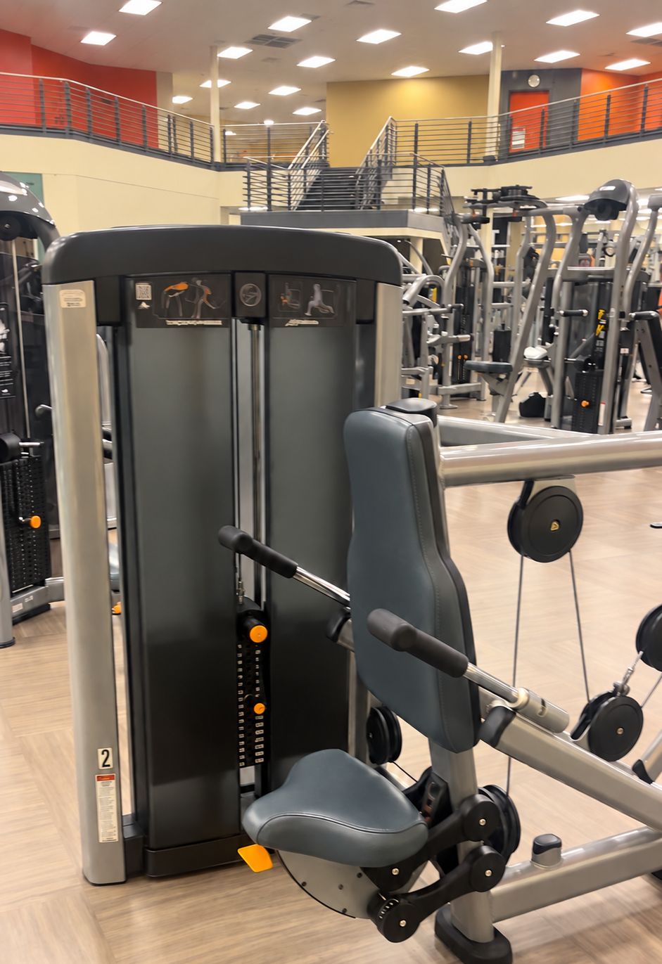 Triceps press, with the stairs to the mezzanine behind